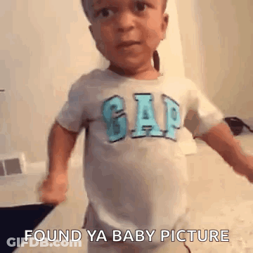 Boy In Gap Shirt Standing On Bed GIF