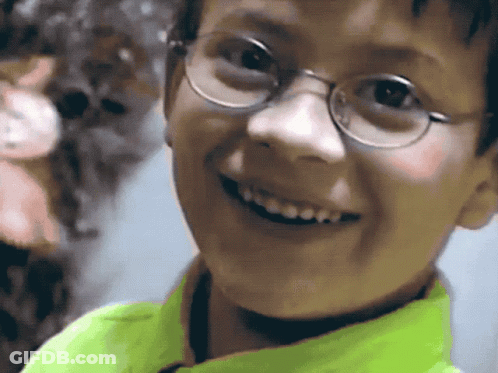 Boy In Glasses And Neon Green Shirt Smiling GIF