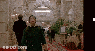 Boy In Green Coat Walking Down Red Carpet GIF