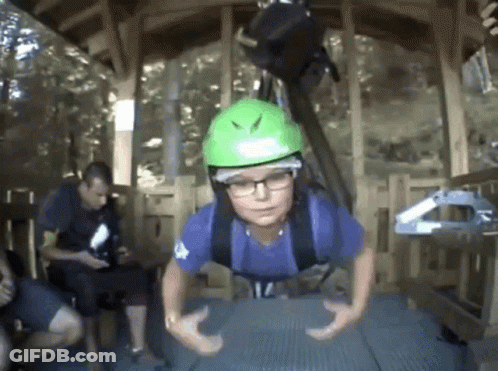 Boy In Green Helmet Hanging Upside Down GIF