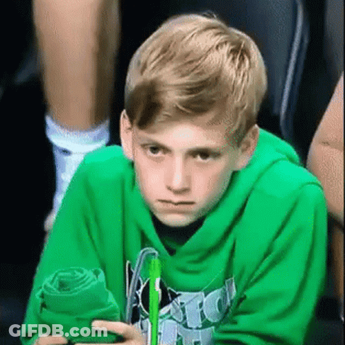 Boy In Green Hoodie Sitting With Towel And Pen GIF