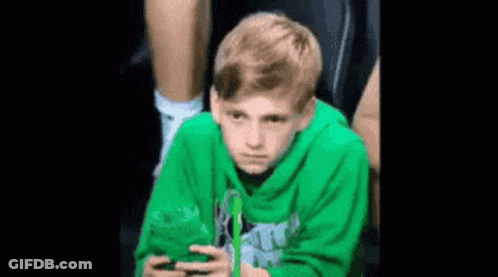 Boy In Green Hoodie Using Phone GIF