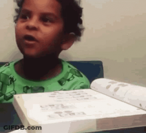 Boy In Green Shirt Holding Book GIF