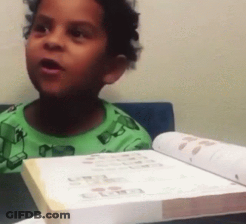 Boy In Green Shirt Reading Book GIF