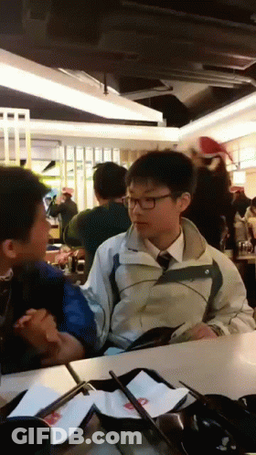 Boy In Jacket And Tie Talks To Another GIF