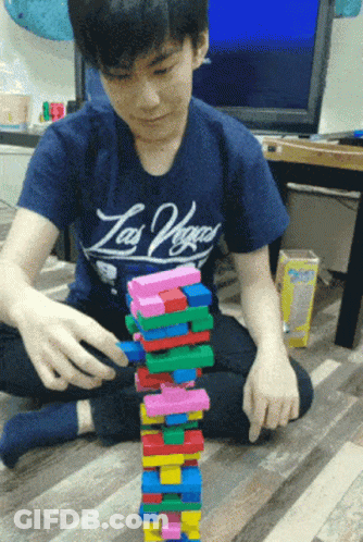 Boy In Las Vegas Shirt Stacks Blocks GIF