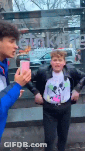 Boy In Mickey Mouse Shirt Taking Picture Of Another Boy GIF