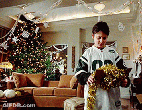 Boy In Number 10 Jersey Decorating Christmas Tree GIF