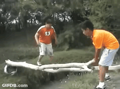 Boy In Orange Shirt 83 Jumping Over Log GIF