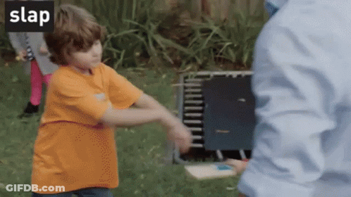 Boy In Orange Shirt Being Slapped GIF