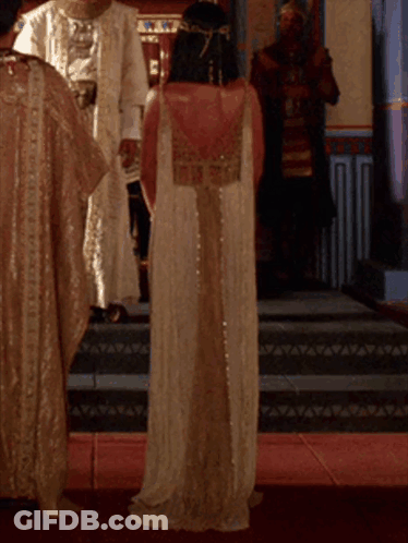 Boy In Pharaoh Costume With Flaming Torches GIF