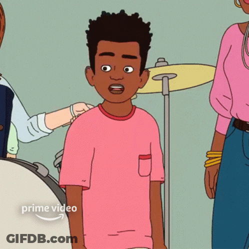 Boy In Pink Shirt Standing In Front Of Drum Set GIF