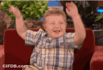 Boy In Plaid Shirt Sitting On Couch GIF