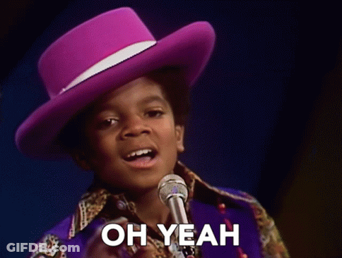 Boy In Purple Hat Singing Into Microphone Saying Oh Yeah GIF