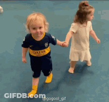 Boy In Qatar Jersey Holding Hands GIF