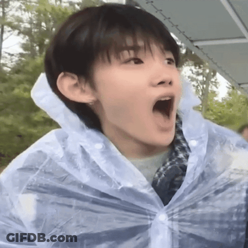 Boy In Raincoat Making Funny Face GIF
