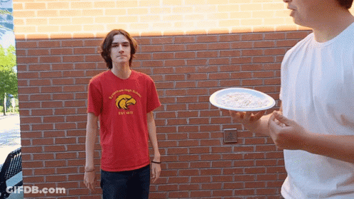 Boy In Red Eagles Shirt Throwing Plate Of Food GIF
