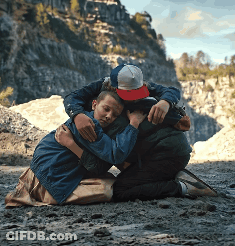 Boy In Red Hat Hugging Another Boy GIF