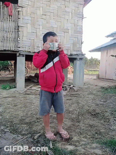Boy In Red Jacket Holding Dollar Bill GIF