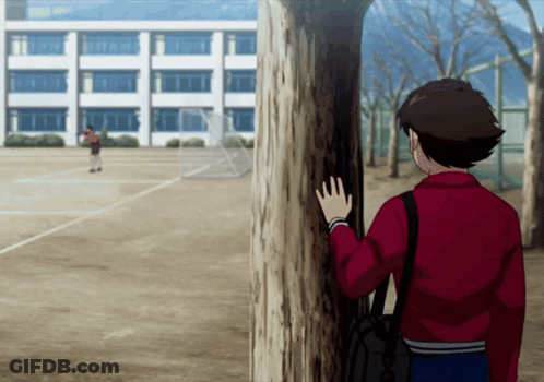 Boy In Red Jacket Next To School Wall GIF