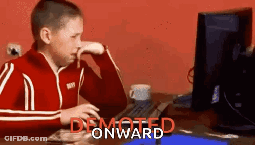 Boy In Red Jacket Sitting At Computer Desk GIF