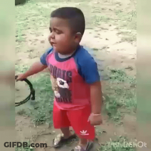 Boy In Red Shirt And Shorts Holding Tambourine GIF