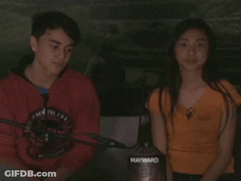 Boy In Red Shirt Talking To Girl In Orange Shirt Holding Maynard Vacuum Cleaner GIF