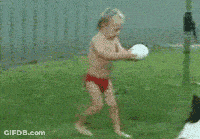 Boy In Red Swim Trunks Running Toward Ball GIF