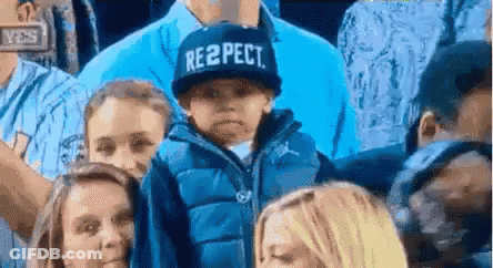 Boy In Respect Hat In Crowd GIF