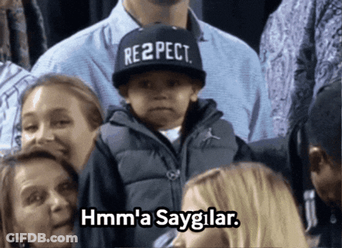 Boy In Respect Hat Sitting In Crowd GIF