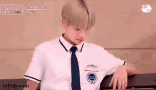 Boy In School Uniform Leaning On Wall GIF