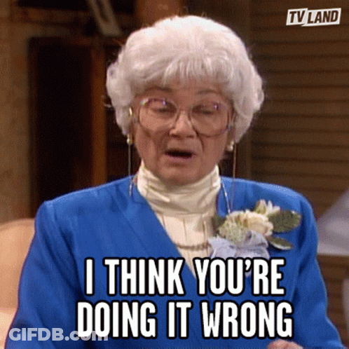 Boy In School Uniform Standing Before Flowers GIF