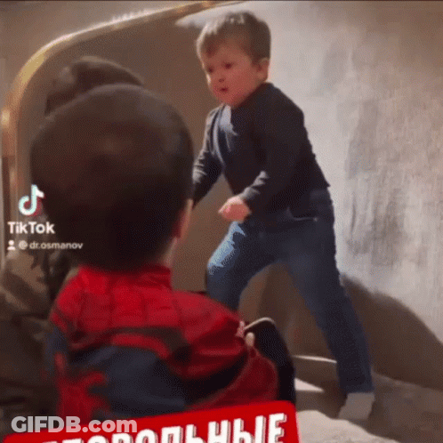 Boy In Spiderman Costume Next To Boy In Black Shirt GIF