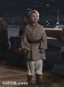 Boy In Star Wars Costume With Lightsaber GIF