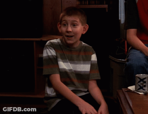Boy In Striped Shirt Sitting In Front Of XXX Can GIF