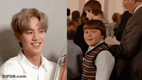 Boy In Striped Vest Smiling Next To Boy In White Shirt GIF