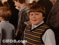 Boy In Striped Vest Standing In Crowd GIF