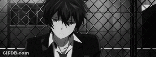 Boy In Suit Sitting In Front Of Fence GIF