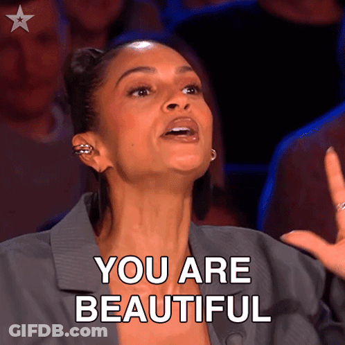 Boy In Sunglasses And Blue Jacket Holding Pom Poms In Crowd GIF