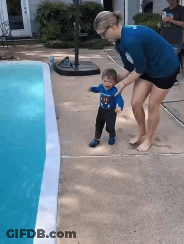 Boy In Superman Shirt Held By Woman GIF