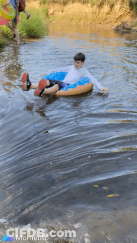 Boy In Tube In River With Momento GIF