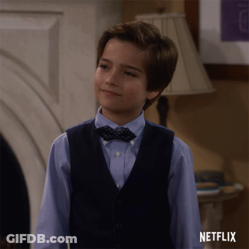 Boy In Vest And Bow Tie At Netflix Logo GIF