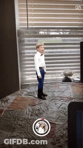 Boy In White Shirt And Blue Pants By Window GIF