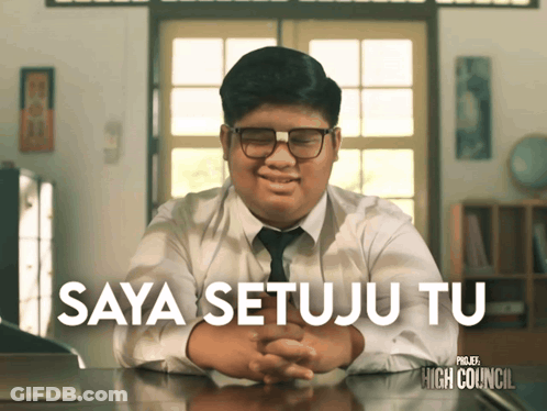 Boy In White Shirt And Tie Sitting At Desk Saya Setuju Tu GIF
