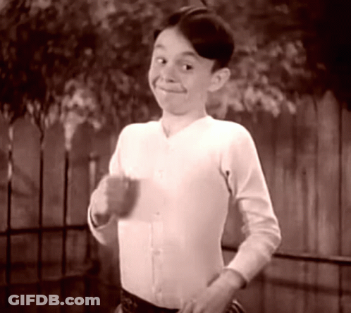 Boy In White Shirt Smiling At Fence GIF