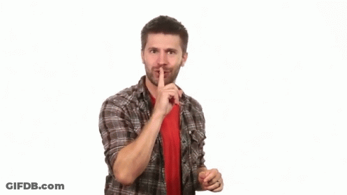 Boy In White Tank Top Making Shhh Sign GIF