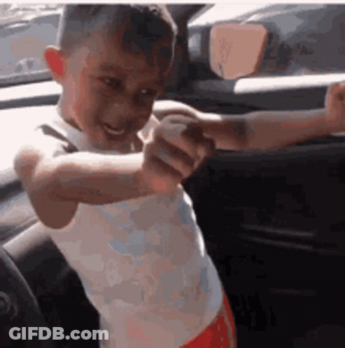 Boy In White Tank Top Pointing At Camera GIF