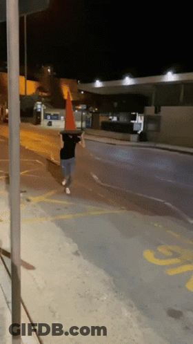 Boy In Witch Hat Amid Traffic Cones Saying Meanwhile At My House GIF