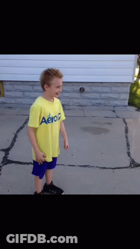 Boy In Yellow Aeropostale Shirt On Sidewalk GIF