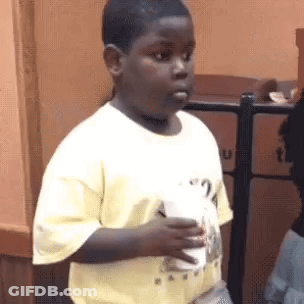 Boy In Yellow Shirt Holding Coffee GIF